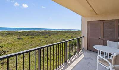 Scenic view of the dune walkway leading directly to the sandy beach and turquoise waters.