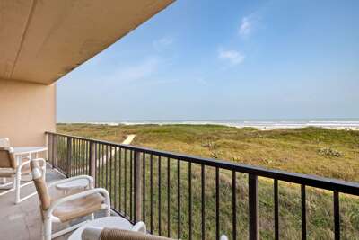 Scenic view of the dune walkway leading directly to the sandy beach and turquoise waters.