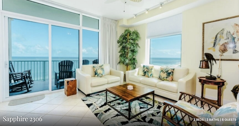 Floor-to-ceiling windows fill this spacious living area with natural light and breathtaking ocean views — a true island retreat.
