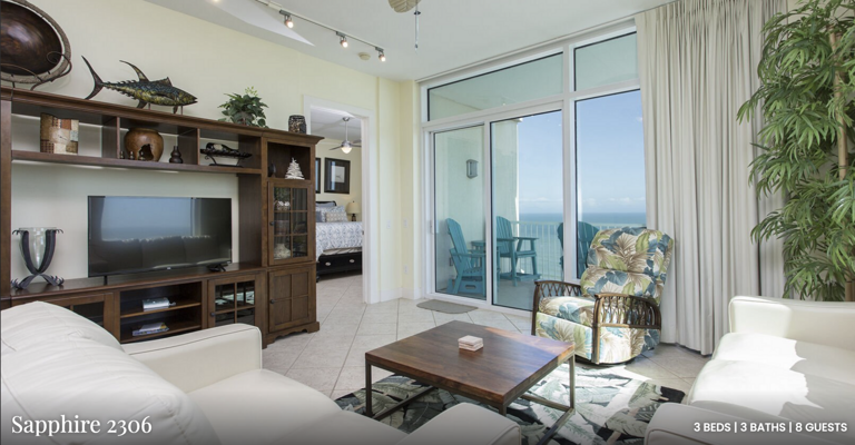 Unwind after a day at the beach in this inviting living room featuring comfortable seating and a large flat-screen TV.
