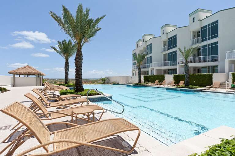 Spend sunny afternoons at the resort-style pool surrounded by palms.