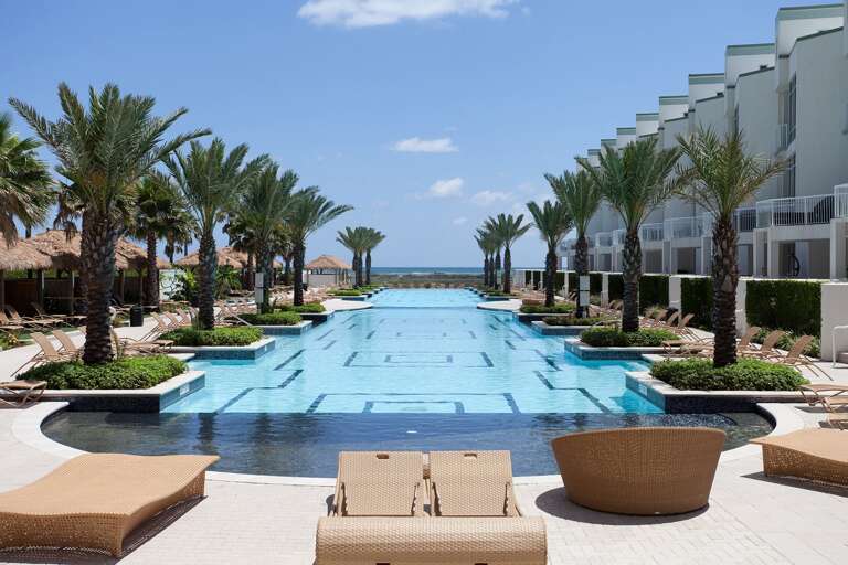 Spend sunny afternoons at the resort-style pool surrounded by palms.