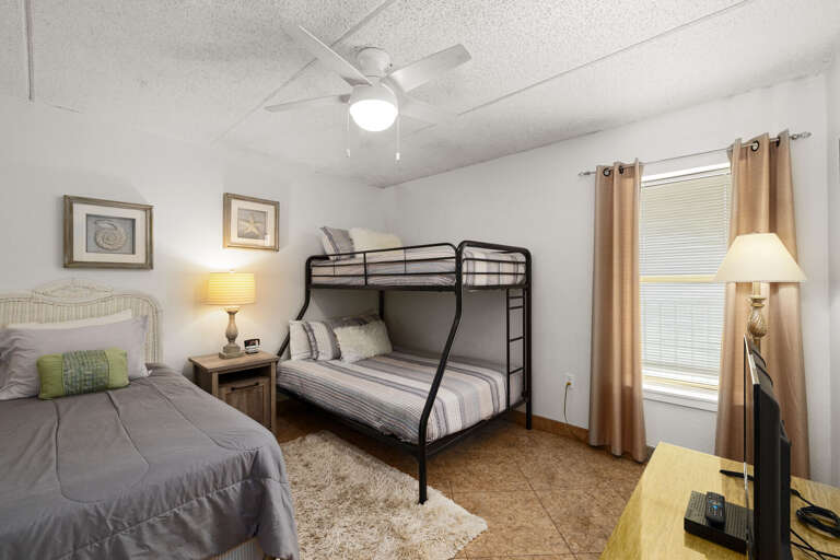 Guest bedroom with a twin bed and twin-over-full bunk, ideal for families or groups