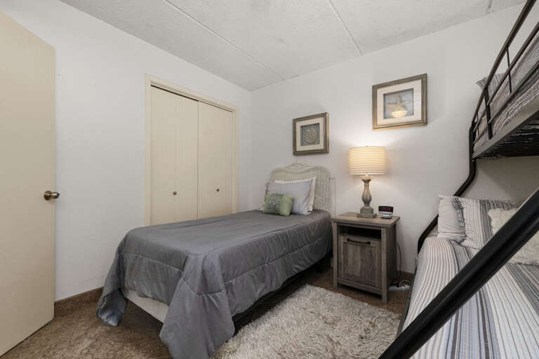 Guest bedroom with a twin bed and twin-over-full bunk, ideal for families or groups