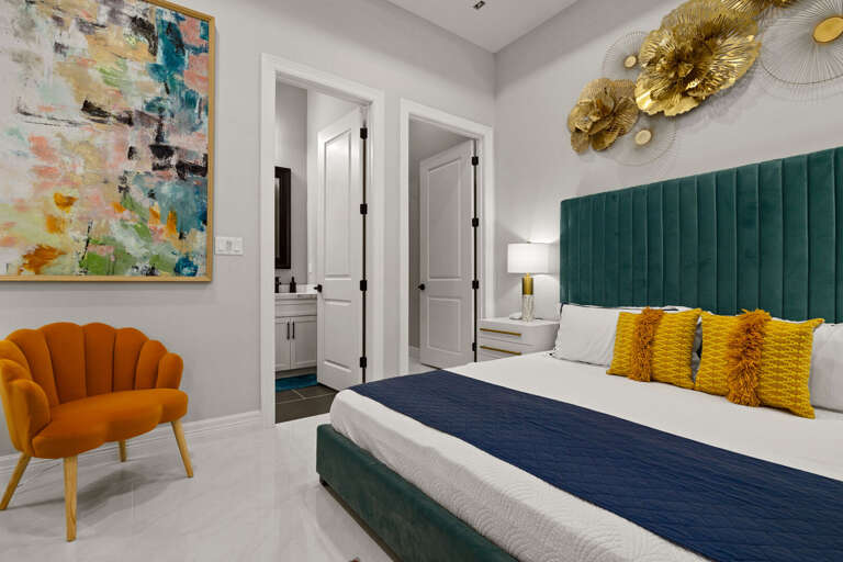 Primary bedroom featuring a king bed, modern finishes, and ample closet space.