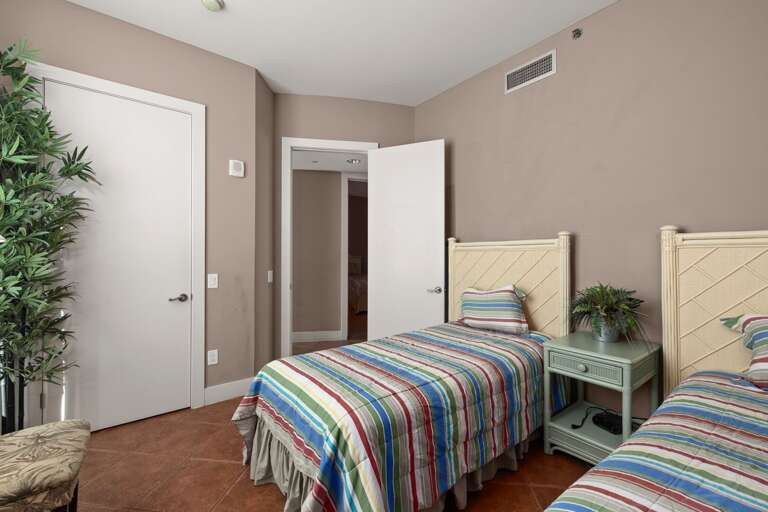Cozy and comfortable guest bedroom features two twin sized beds, perfect for a restful stay in style.