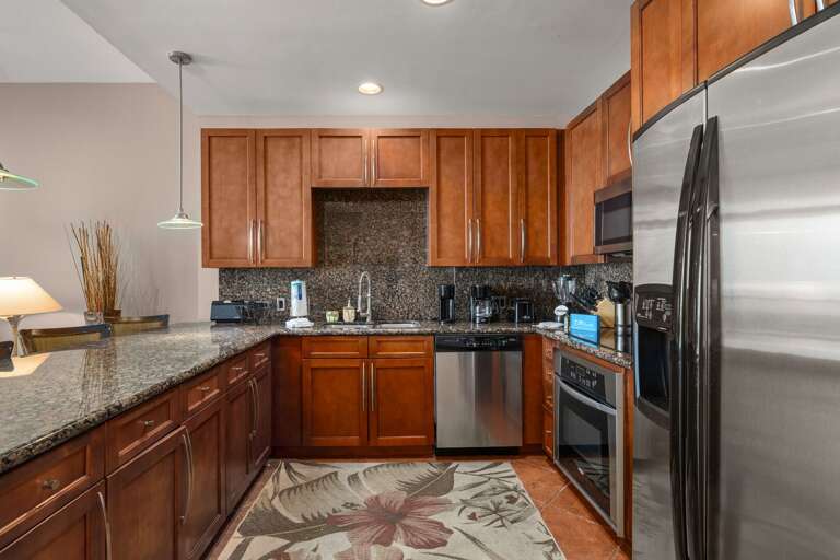 Prepare meals in style with beautiful granite countertops and modern stainless appliances in this chef's kitchen.
