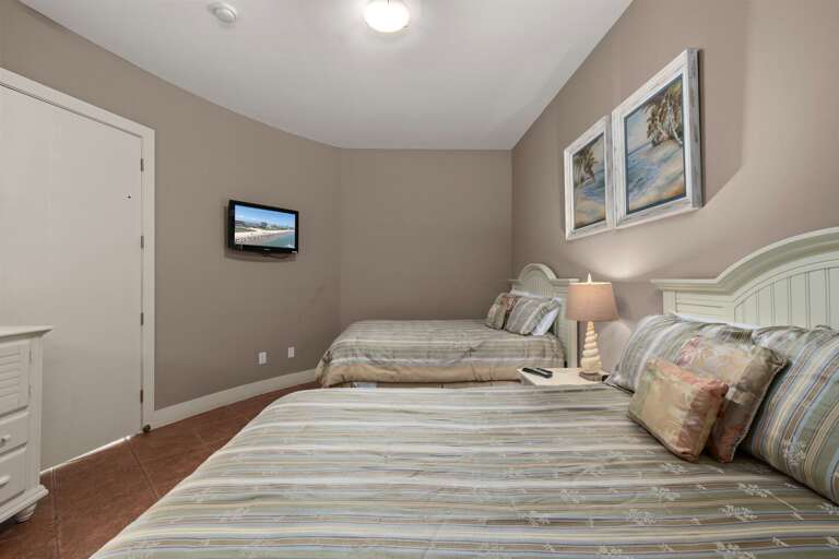 Relax in the second guest bedroom, featuring bright décor, plenty of space, and comfortable full beds for your guests