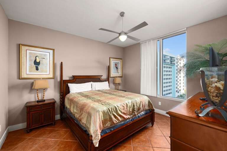 Relax in the spacious master bedroom featuring a comfortable king sized bed.