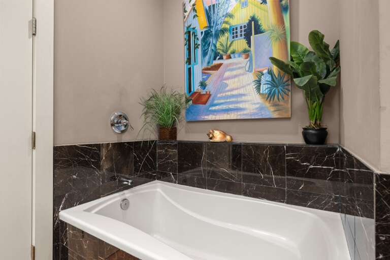 Unwind after a day at the beach in the relaxing soaking tub, a perfect spot to de-stress and enjoy the tranquility of your vacation.