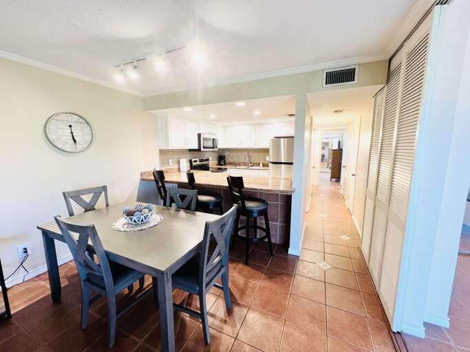 Dining area with seating for four, conveniently located next to the fully equipped kitchen and breakfast bar with additional seating for three.