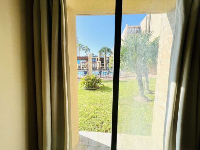 View from the guest bedroom looking out toward the landscaped grounds and resort-style community.