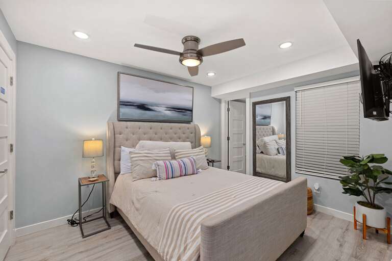 Unwind in the comfortable primary bedroom, designed for restful nights after a day at the beach.