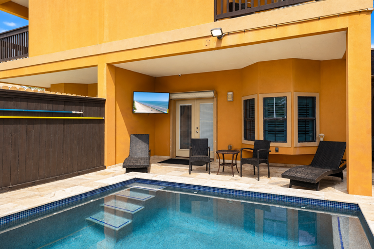 Cool off in the pool and unwind under the covered patio area.