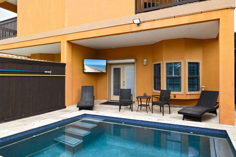 Cool off in the pool and unwind under the covered patio area.