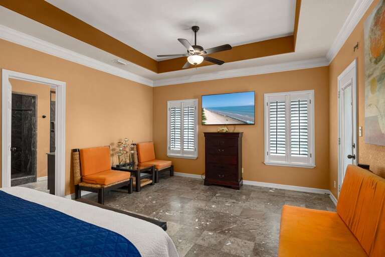 Master suite features a large walk-in closet, private balcony overlooking the pool, and a flat screen TV.