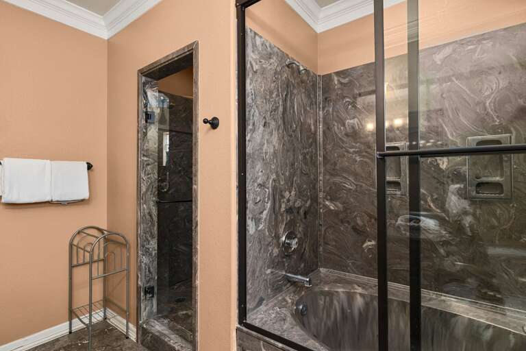 You can refresh and unwind in this spacious master bathroom, complete with a walk-in shower and large soaking bathtub.