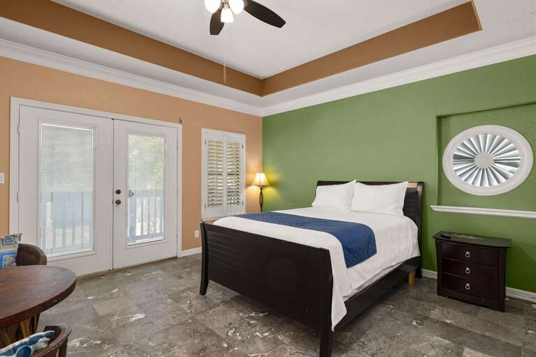 Relax in comfort in this spacious fourth bedroom, where a queen bed and warm ambiance make it easy to recharge.