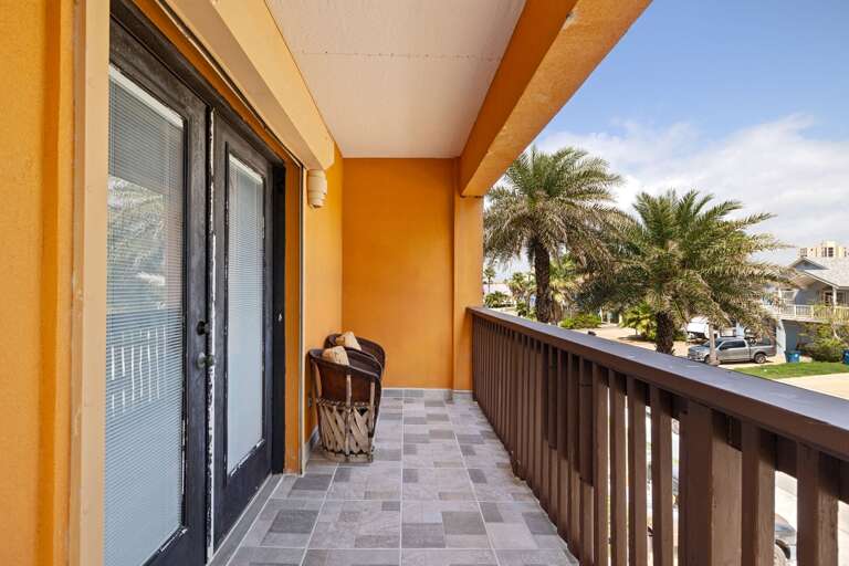 Relax on the streetside balcony with warm coastal air