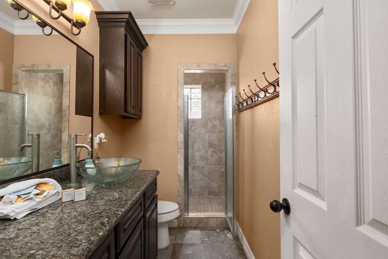 Upstairs guest bathroom with walk-in shower and large vanity.