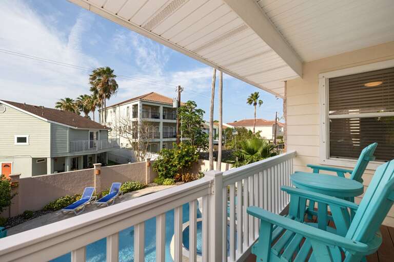 Master bedroom provides access to a balcony overlooking the pool