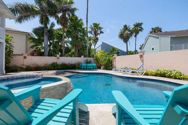 Poolside oasis with lounge seating, perfect for sunny days and quiet evenings