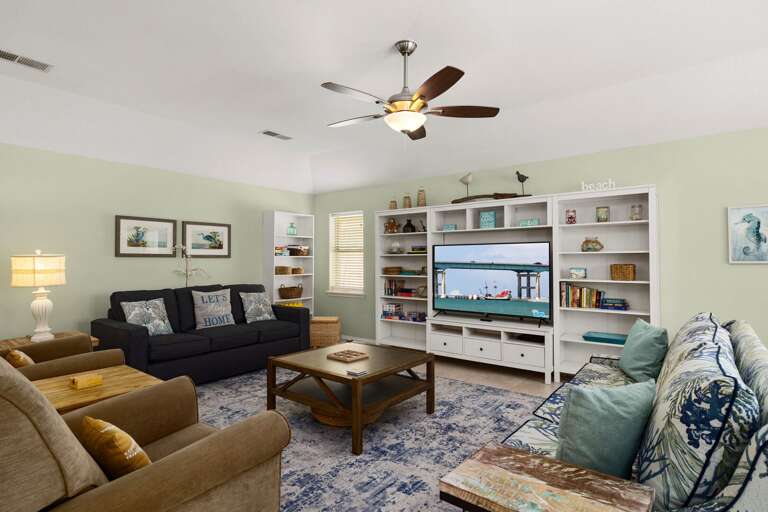 Relax in a bright living space with plush seating and a large TV for movie nights