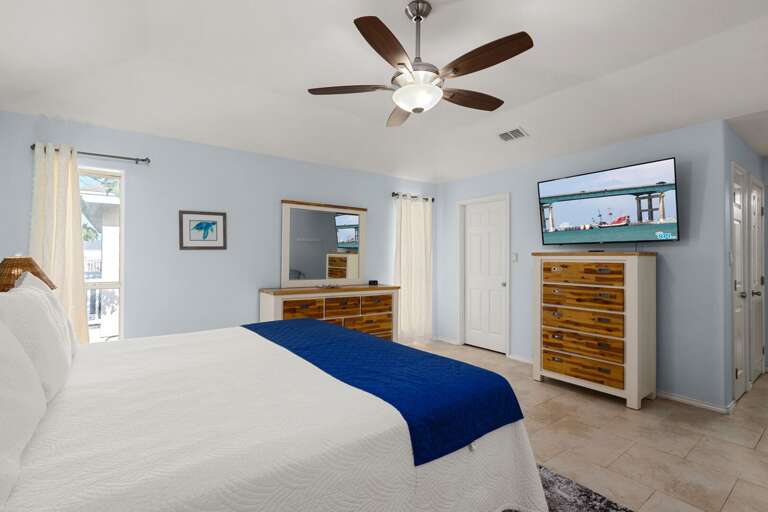 Spacious master suite with TV and king bed