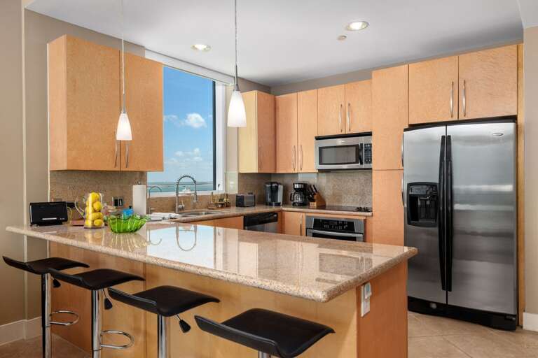 Cook favorite meals in a bright kitchen with water views and bar seating