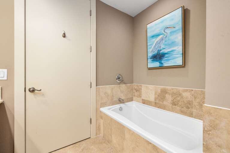 Shared guest bath with soaking tub and modern coastal finishes