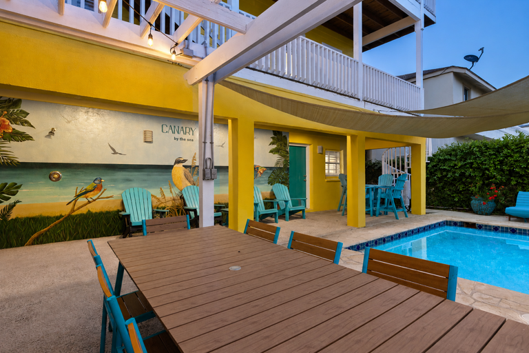 Gather around the outdoor dining table for meals, laughs, and time together by the pool.