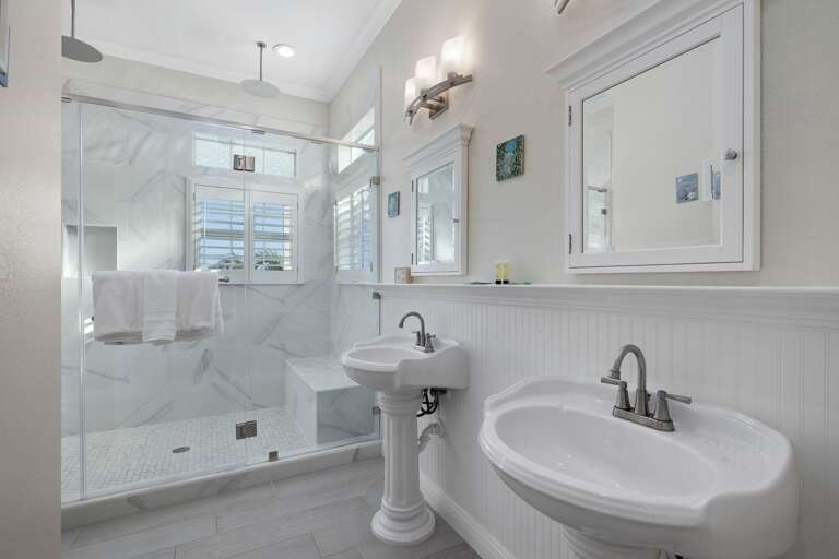 The primary ensuite features double vanities and a beautifully updated walk-in shower.