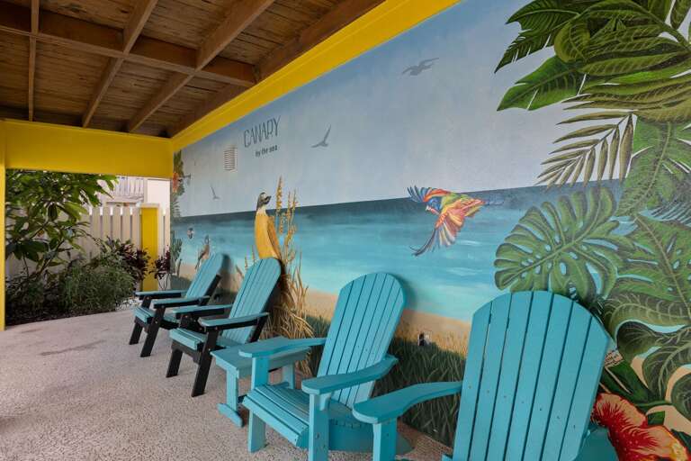 Relax beside the colorful island mural while enjoying the tropical outdoor seating area.