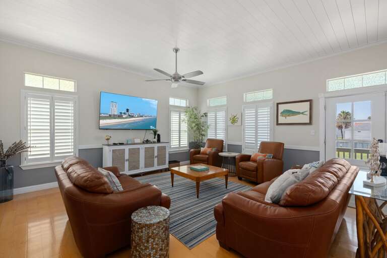 Settle into the bright, open living room with comfortable seating for everyone to relax after a day at the beach.