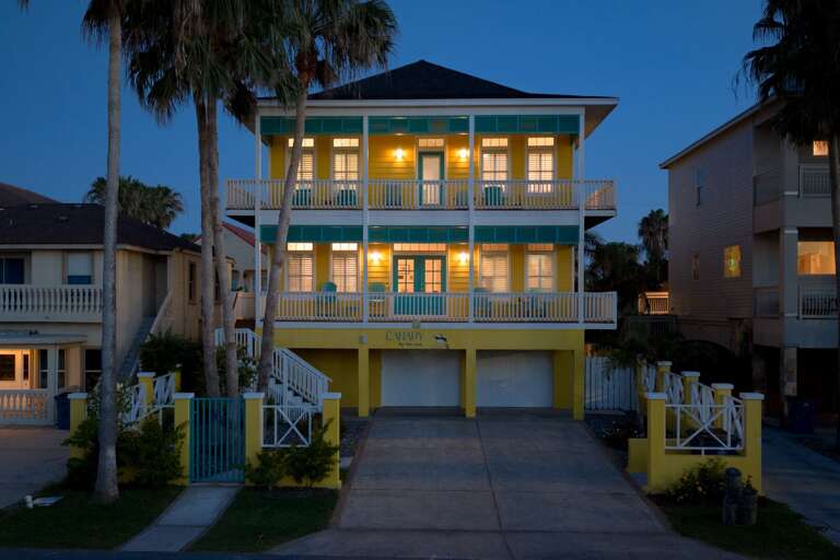The home shines beautifully at dusk, creating the perfect welcome after a day on the island.