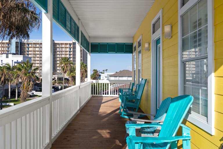 The spacious front balcony is a wonderful place to enjoy fresh coastal breezes throughout the day.