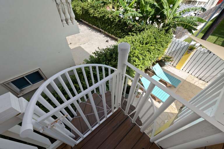 Step outside and head down to the pool from the upstairs balcony.