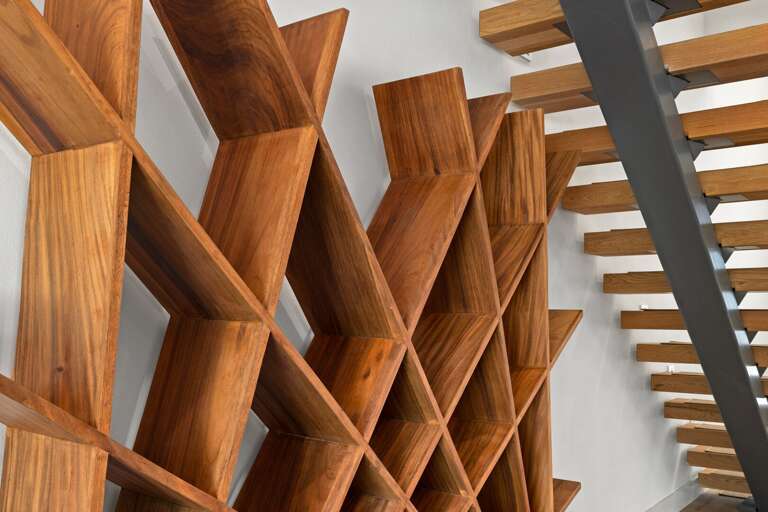 A closer look at the custom wood shelving and modern floating staircase that make this home truly unique.