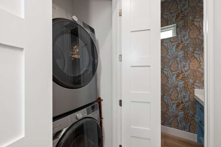 Enjoy the convenience of a private laundry area with a stacked washer and dryer during your stay.