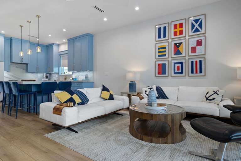 Gather in the bright, open living room featuring comfortable seating, coastal accents, and plenty of space to unwind.