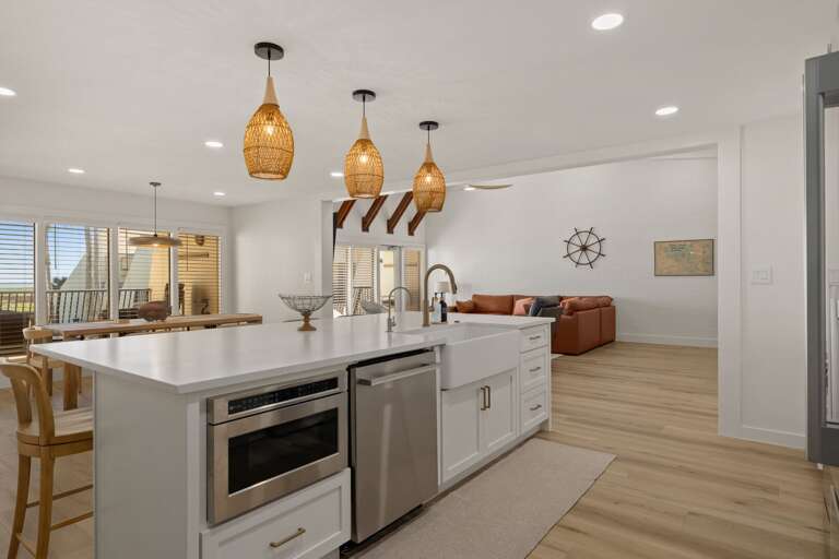 Prepare meals in the fully equipped kitchen with a large island, modern appliances, and an open layout.