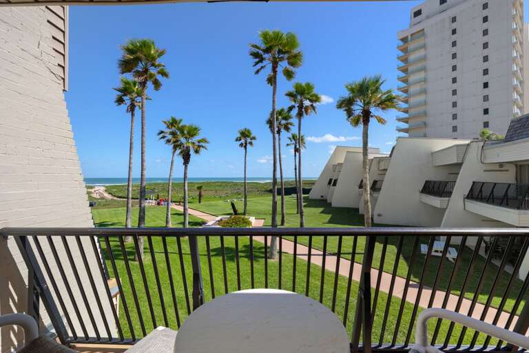 Start your morning with coffee on the covered balcony overlooking the Gulf and swaying palm trees.