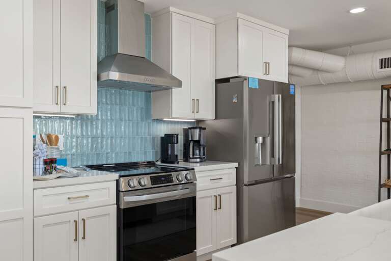 Cook with ease in the updated kitchen featuring a gas range, generous counter space, and modern finishes.
