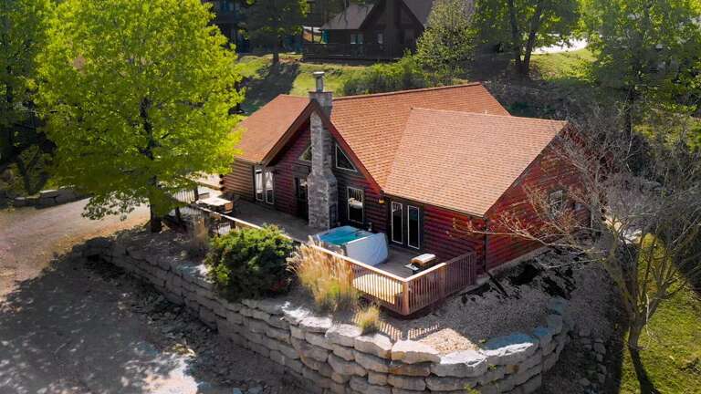 Aerial View Of A Rustic House With A Pool