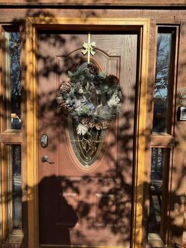 Wooden Door With Decorative Wreath, Sunlight Shadowing Branches