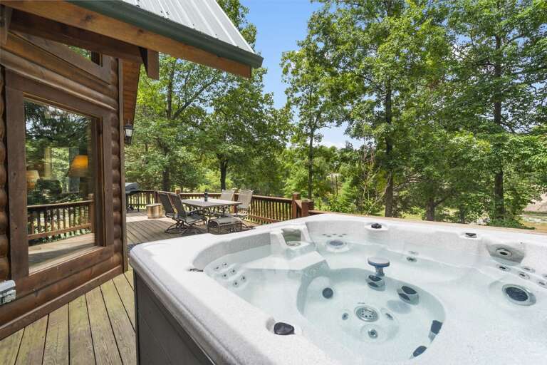 Outdoor Jacuzzi On Wooden Deck With Trees In Background