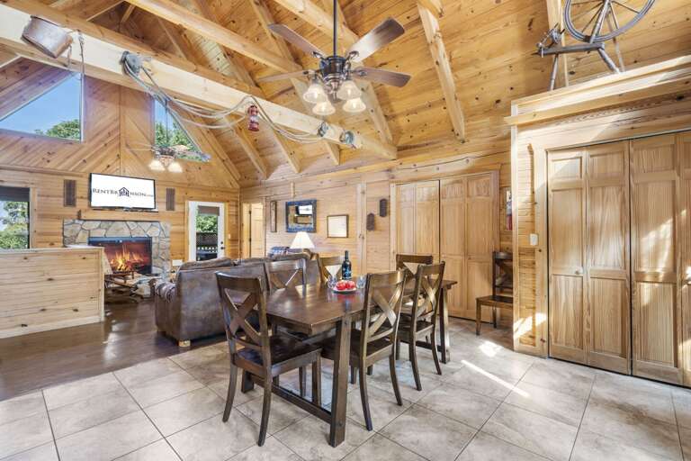 Wooden Interior With Dining Table, Chairs, And Fireplace