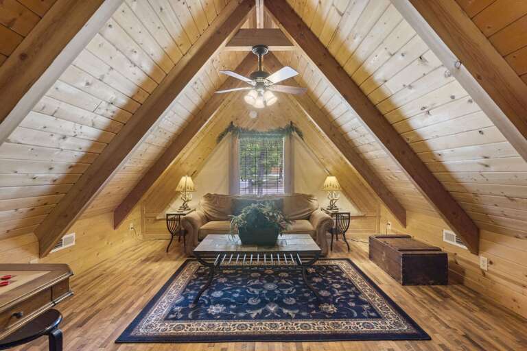 Attic Living Space With Wooden Ceiling And Furnishings Attic Living Space With Wooden Ceiling And Furnishings