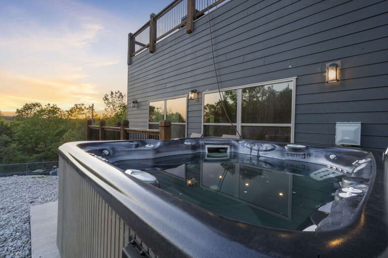 Outdoor Hot Tub On Deck At Vacation Rental At Dusk