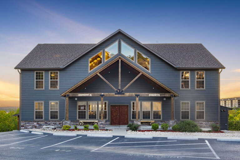 Two-story Building With Parking Lot At Dusk